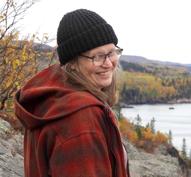 Kirsten Voohees on a high cliff