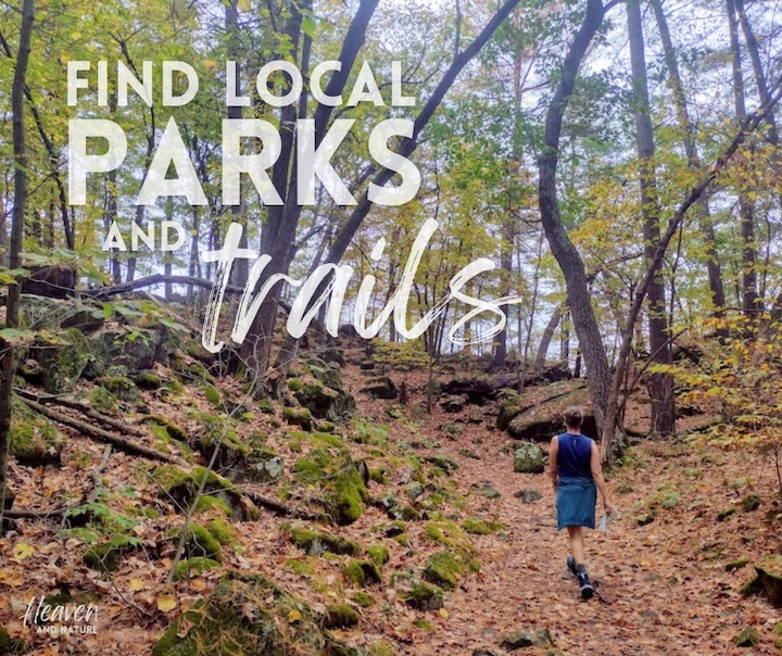 "find local parks and trails" with image of woman hiking in the autumn woods