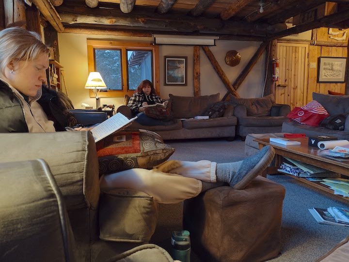 two women sitting in a lodge having their devotions