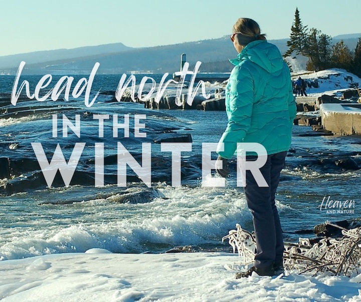 "head north in the winter" with image of woman standing on a lake shore in the winter