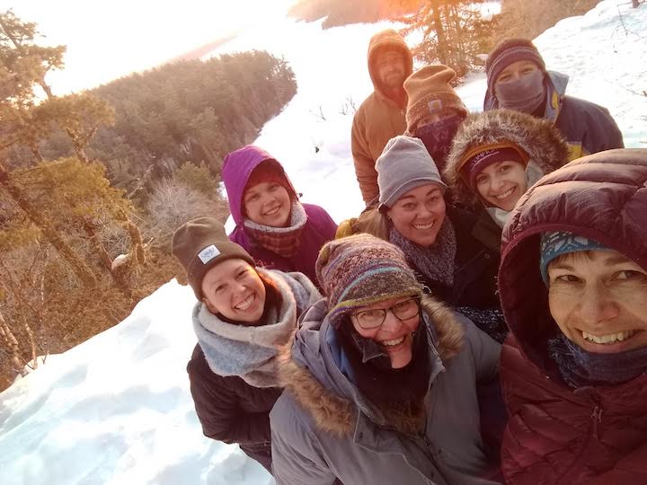 group all bundled up for a cold winter sunrise