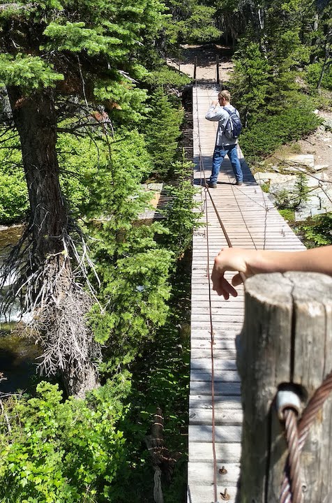 hiker on the swing bridge over Paradise Creek