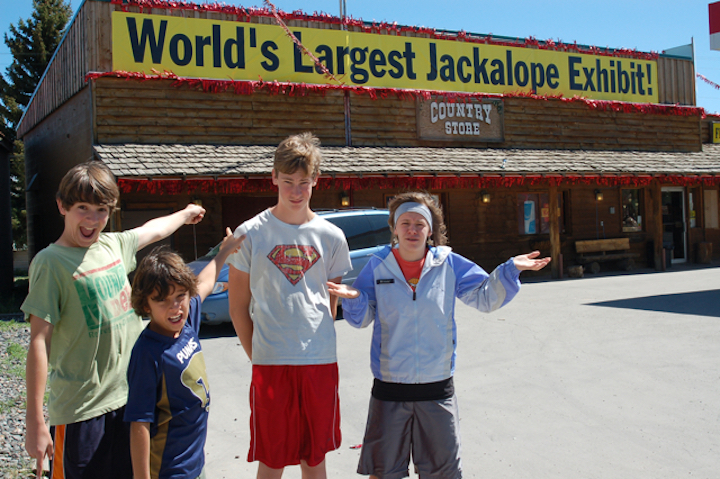 4 children standing in front of a building that says "World's Largest Jackalope Exhibit!"