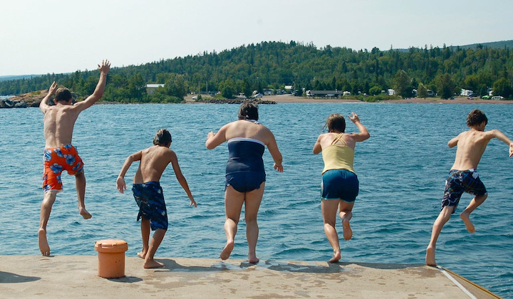 five kids jumping into the water