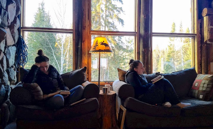 two women in comfy chairs reading Bibles