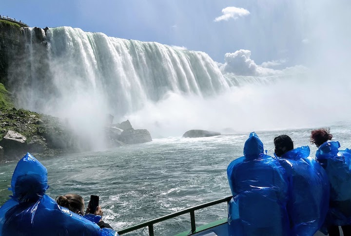 boaters on the Niagara River look over to American Falls