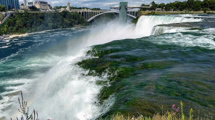 brink of American Falls, Niagara River, from Goat Island...international bridge in the background