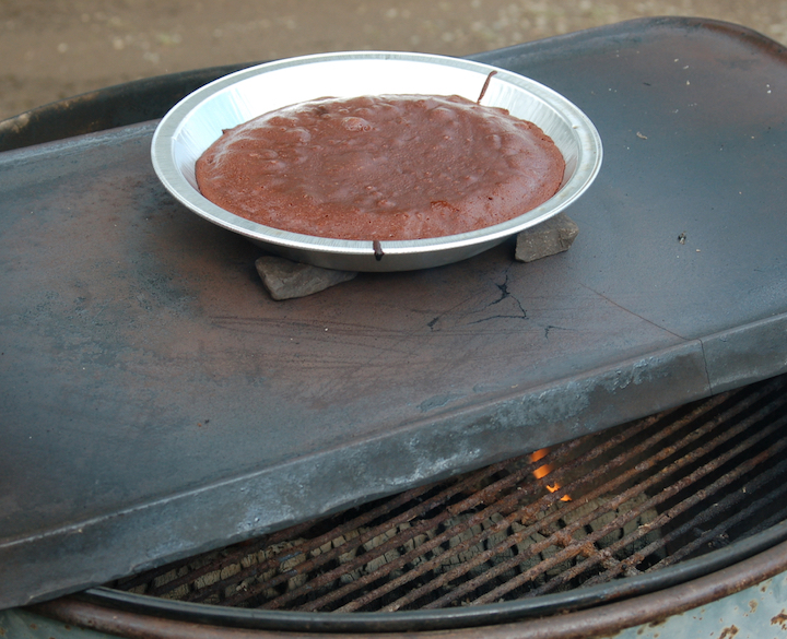 pan of brownies baking over a wood fire