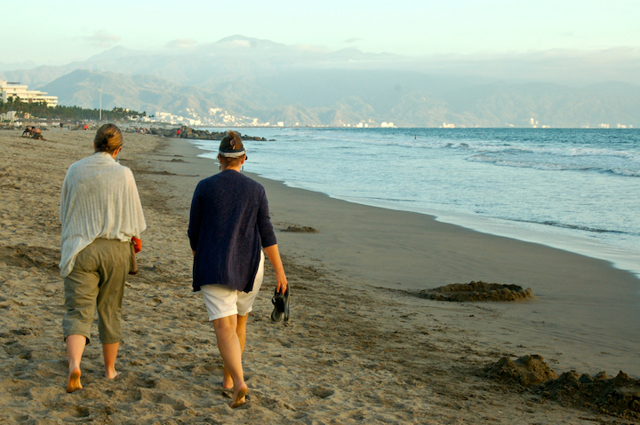 two women walking along a beach, Mexico