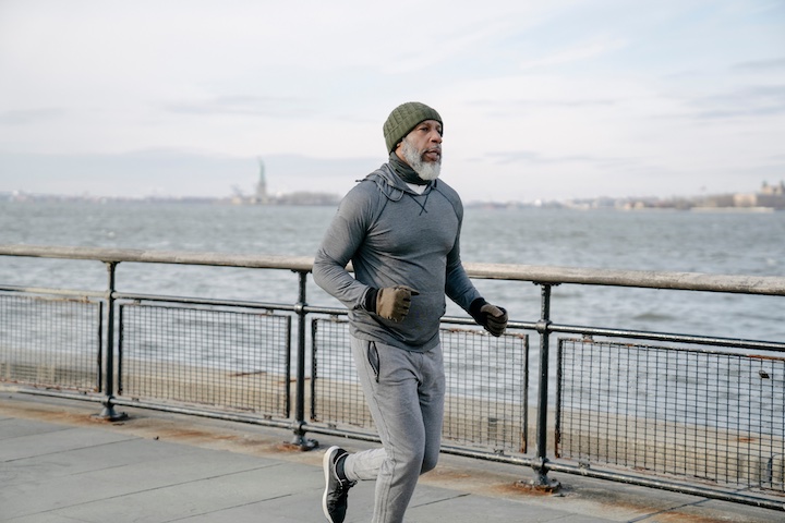 older man running along the bay