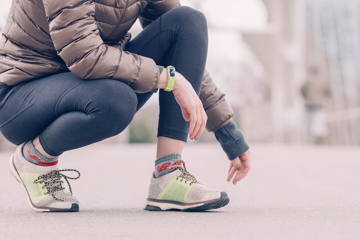 woman kneels before a run