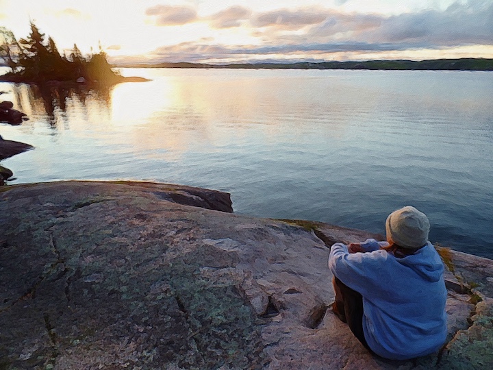 painted image of a woman sitting on a rock at a lake's edge, watching the rising sun