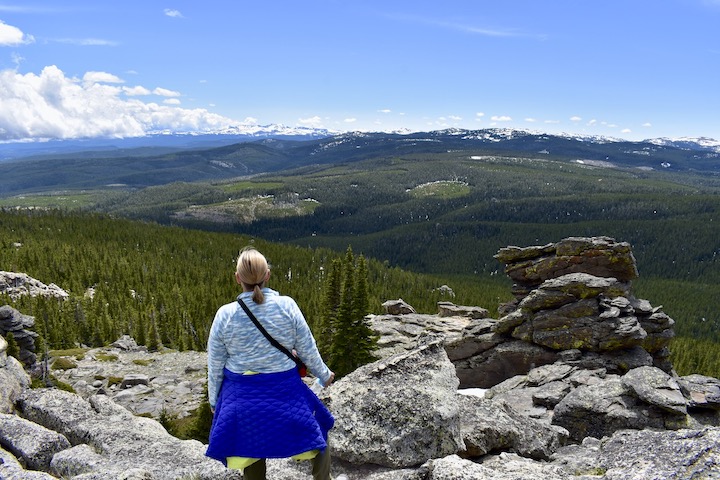 Sharon stands on Black Mountain overlooking Bighorn National Forest