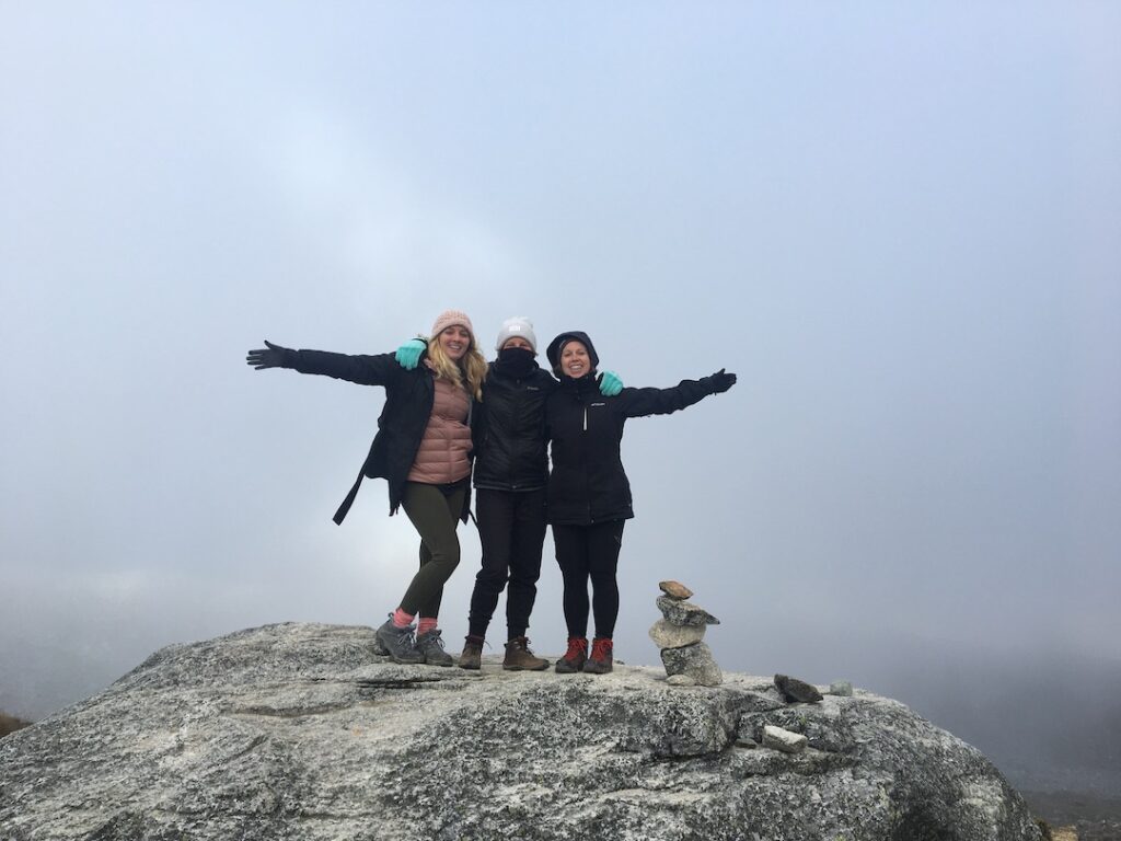 three women on a peak in the Andes Mountains