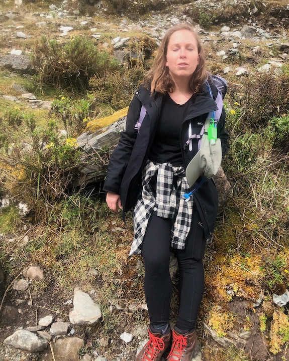 the author rests along side the trail on a high-elevation backpack trip