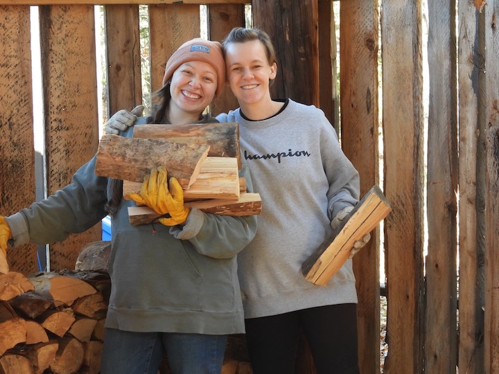 two young moms stack wood