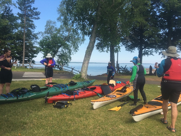 group of women preparing for a sea kayak trip