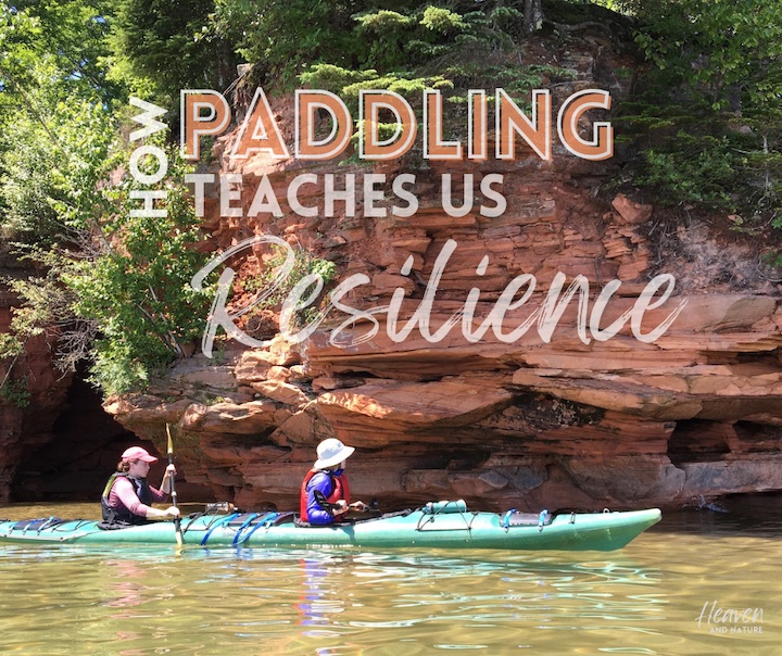 "How Paddling teaches us Resilience" with image of two women in a tandem sea kayak along a rocky shoreline