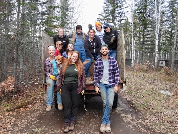 group of young people in a trailer in a wooded camp