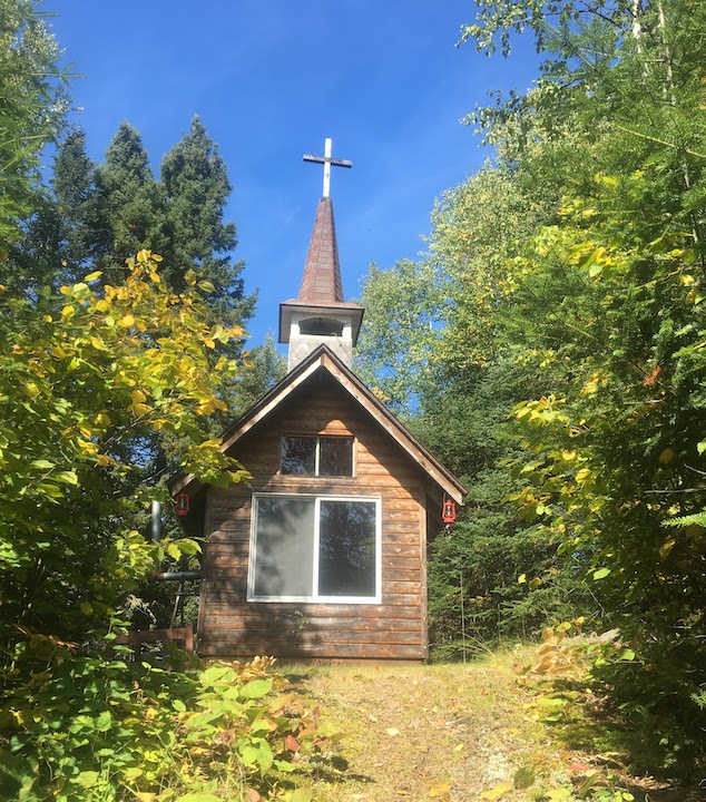 log chapel on a woodsy hilltop