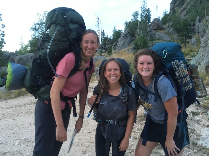 three women with big backpacks on , ready for an adventure