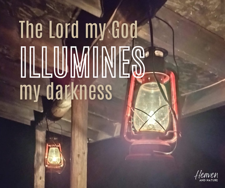 "The Lord my God illumines my darkness" with image of two red lamps shining at night under the eave of a cabin
