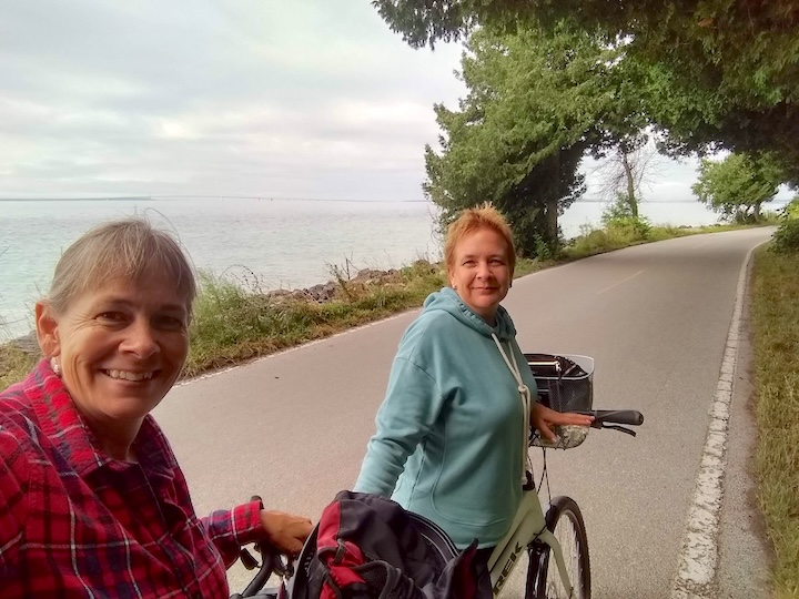 sharon and Lisa with their bikes on highway M185 on Macknac Island
