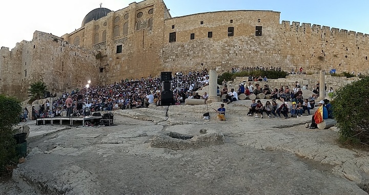 a large group praises God near the Temple Mount in Jerusalem